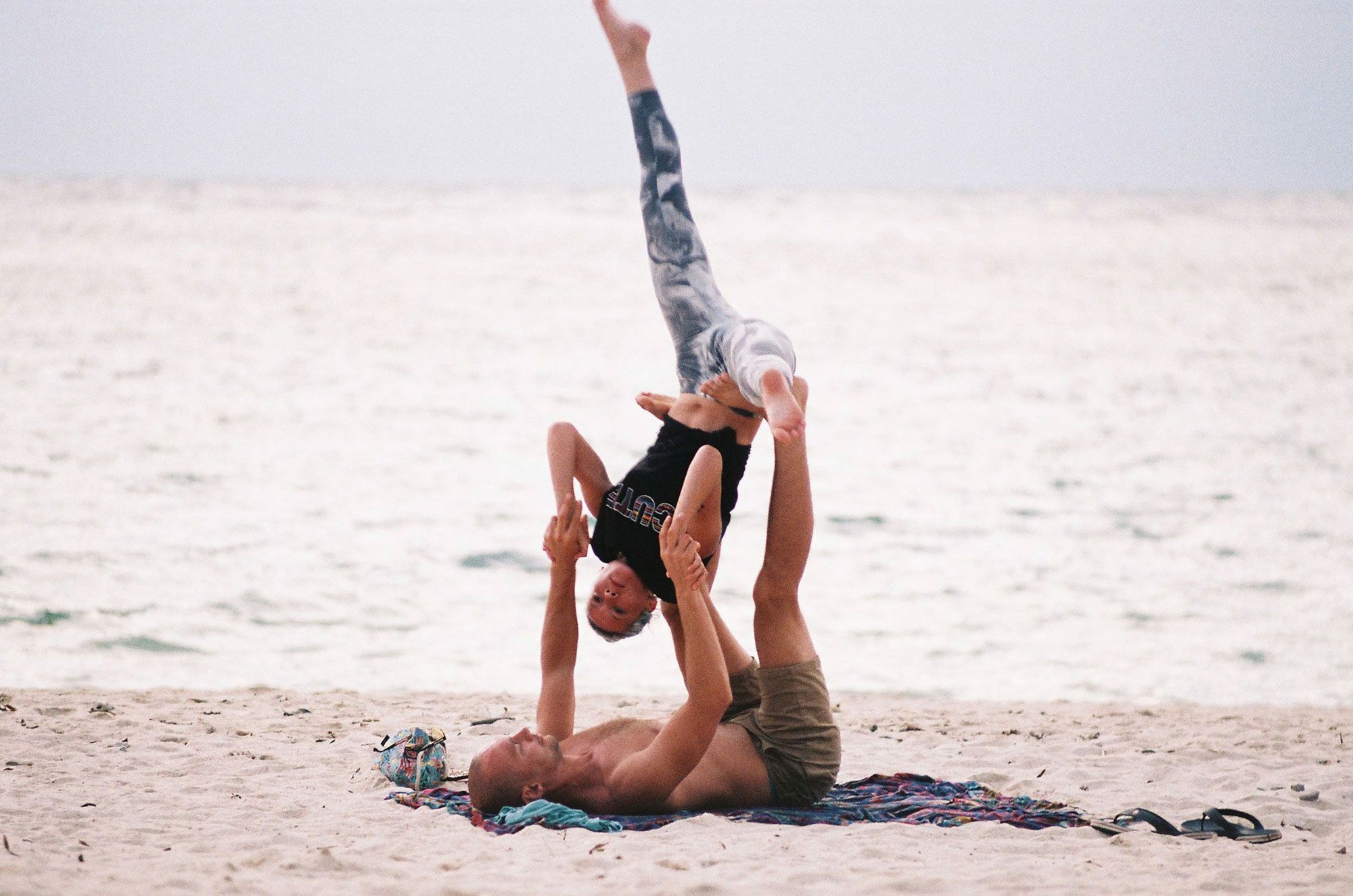 Couple Doing Yoga on the Beach